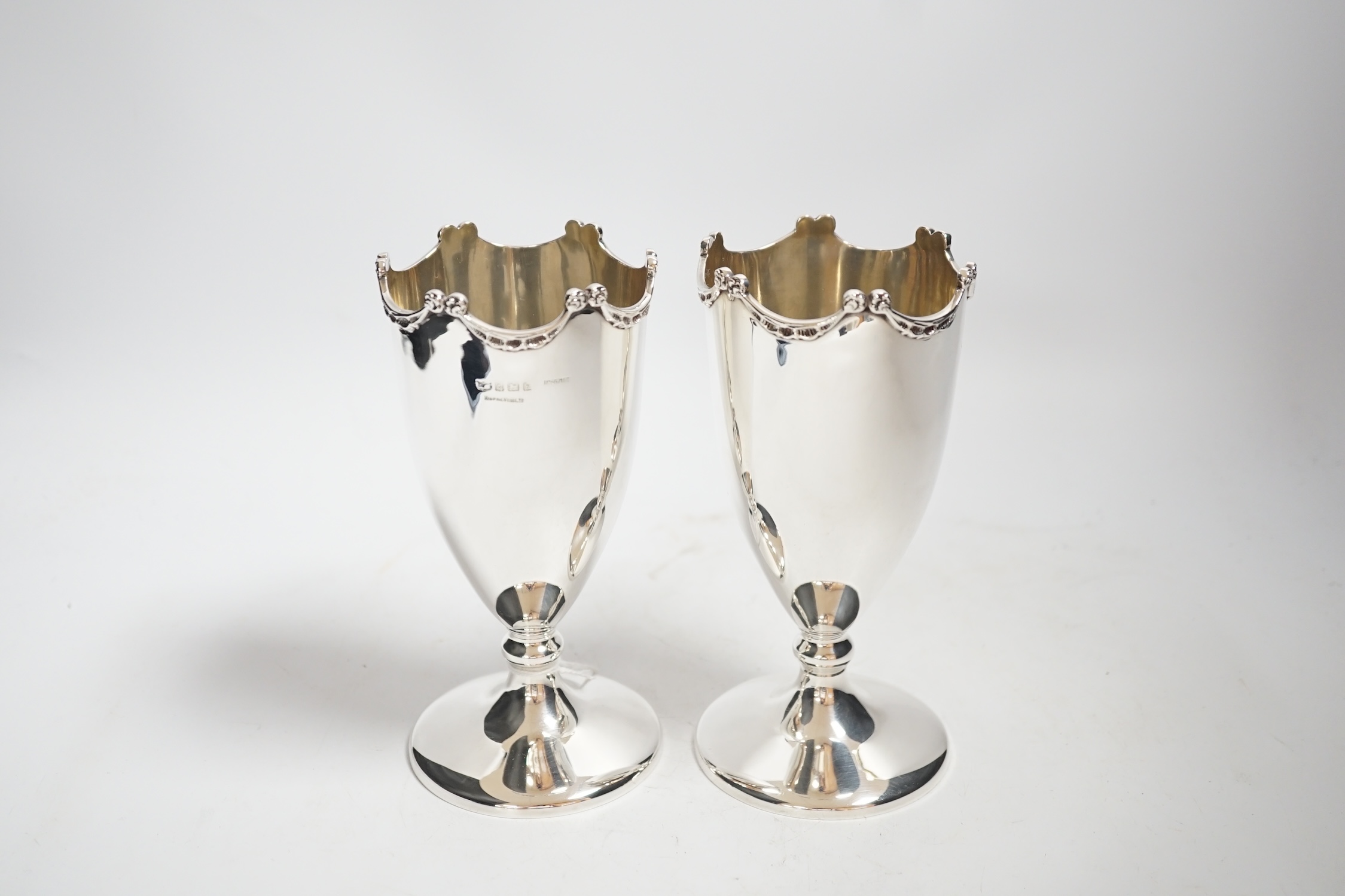 A pair of Edwardian silver pedestal vases, by Mappin & Webb, Birmingham, 1909, 17.1cm, 13.7oz.